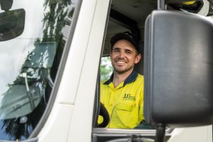 Beau recycling waste driver inside truck